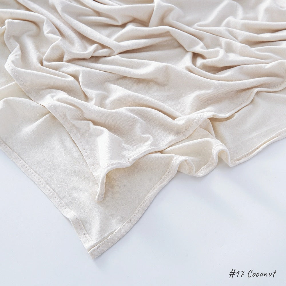 Flat lay of the soft modal cotton scarf wrap showing the even weave and finished border edge
