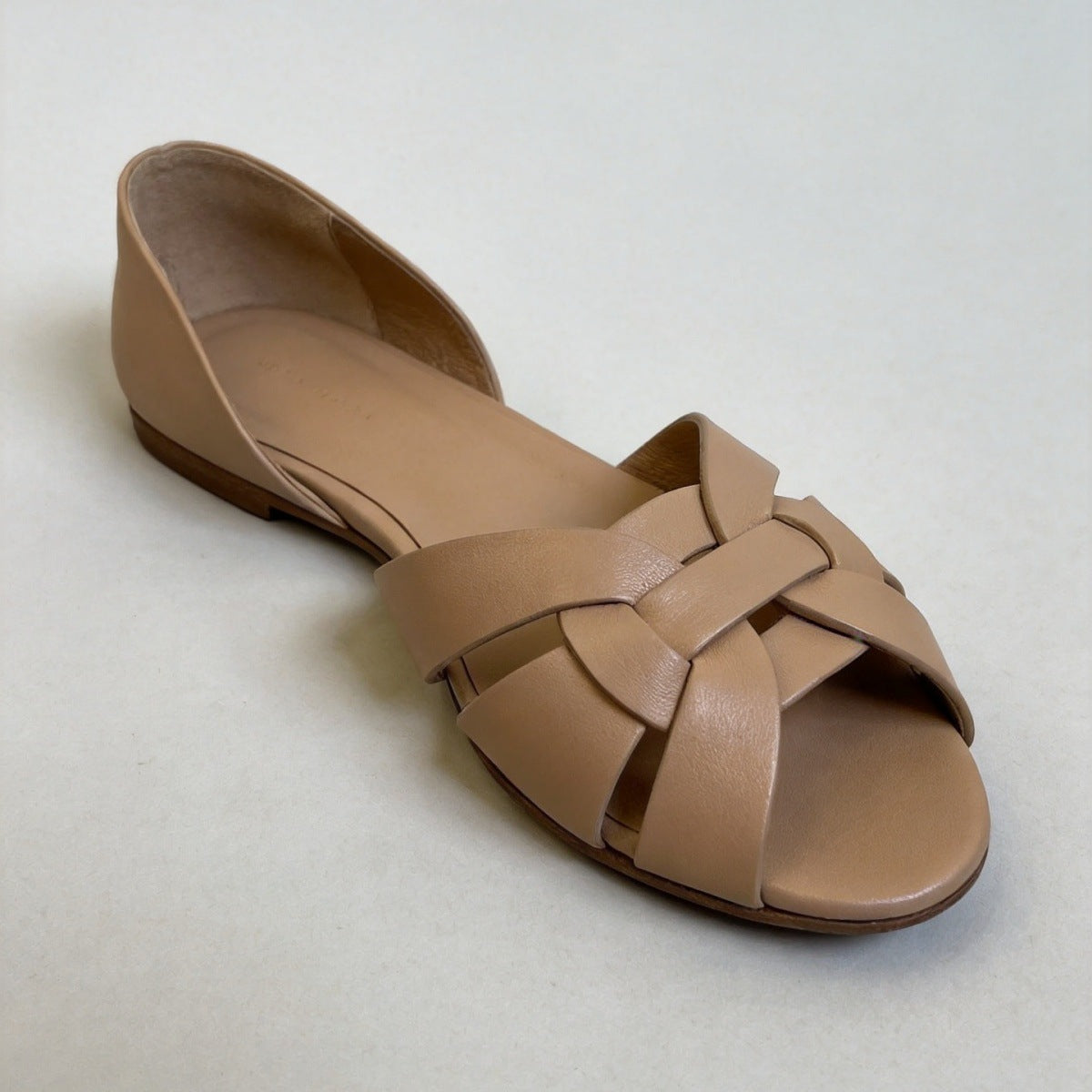 Woven peep toe flat with interlaced leather straps across the instep