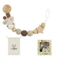 Wood bead pacifier chain shown with hand for scale