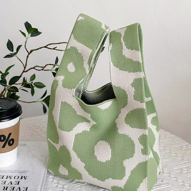 Soft knit wrist bag with an open top and a jacquard knitted pattern