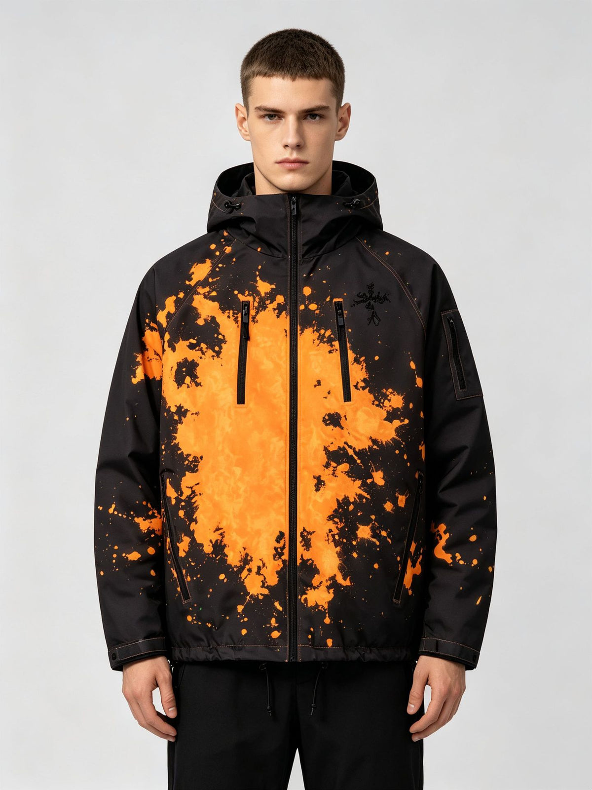 Man wearing the black hooded jacket with an orange splash ink print, option photo for size S