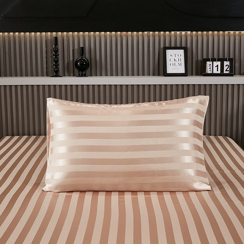 Two satin pillowcases stacked to show different shades