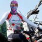 Rider on a bike trail wearing the purple monster print balaclava over a white long sleeve top