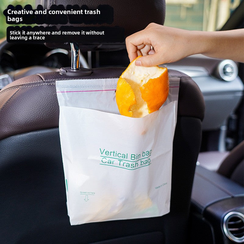 White trash bag stuck to the back of a car seat with a hand dropping an orange peel into it