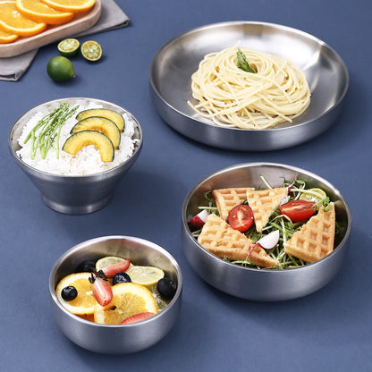 Brushed 304 stainless steel double wall bowl and plate with food on a table