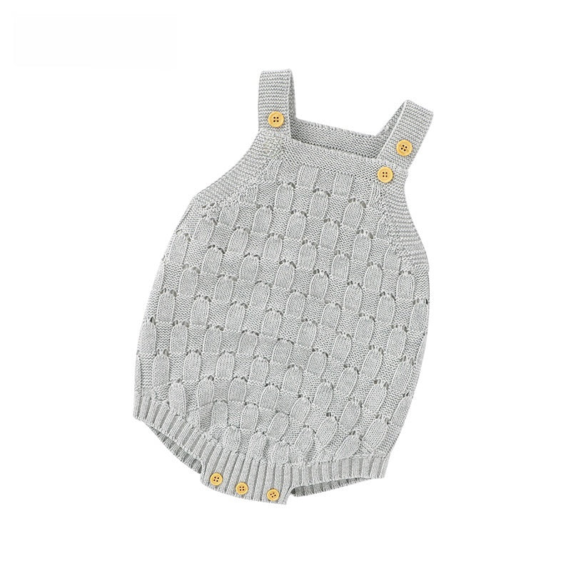 Pink knit baby romper showing the buttoned shoulder straps and open pointelle pattern