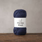 Merino wool yarn ball band showing the one hundred percent merino label