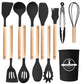 Full black utensil set displayed flat, from turners and spoons to tongs, whisk and holder