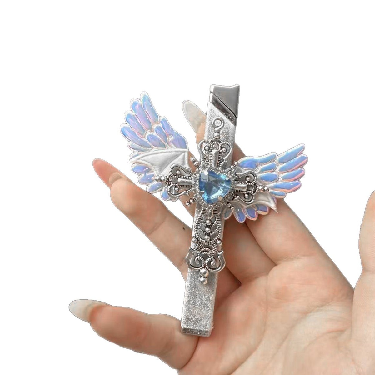 Hand holding the lighter on a white background, showing the cross ornament, wings and blue heart rhinestone