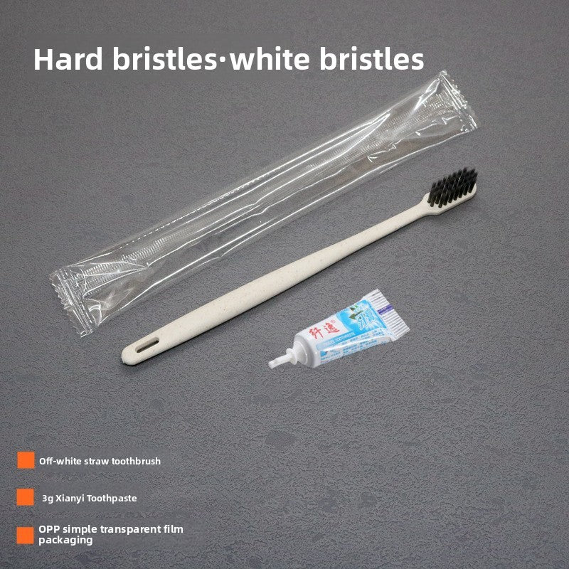 Off white straw toothbrush with a toothpaste tube and clear film packaging, labeled hard bristles