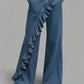 Wide leg denim trousers with a cascading diagonal ruffle down the front and a long leg