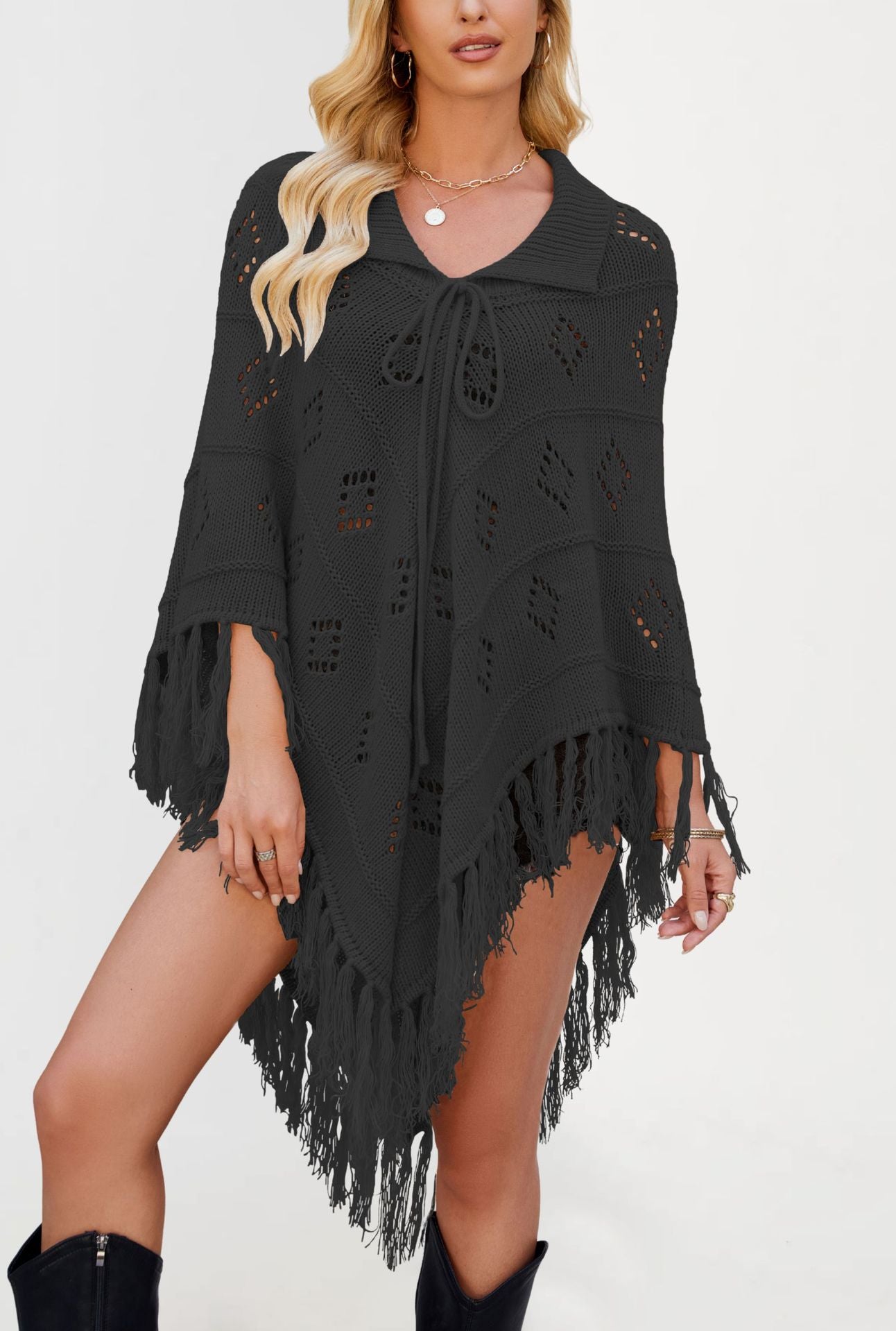 Draped knit poncho with openwork eyelet stitch, collar front tie and tassel fringe hem