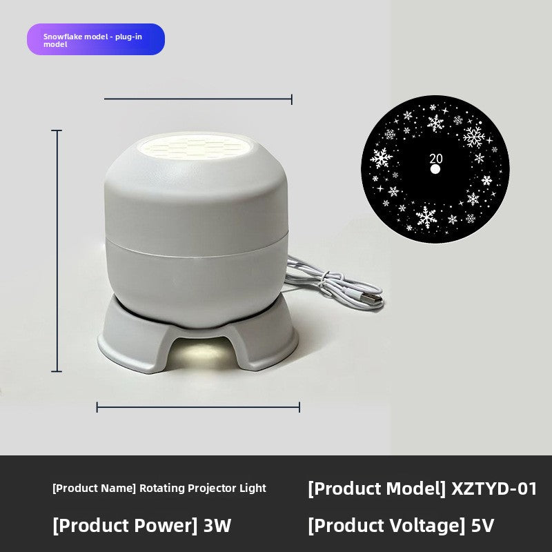 Rotating projector light with USB cable and a snowflake pattern disc, warm glow under the base, plug-in model