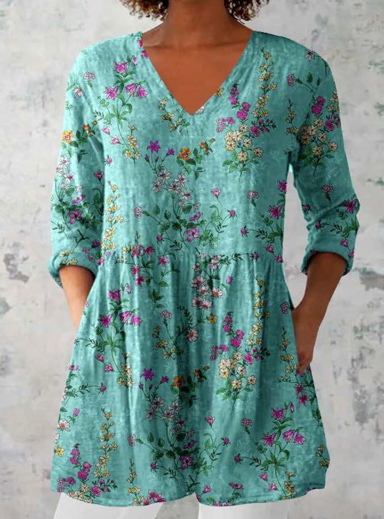 Loose fit printed V neck tunic with a bordered print building toward the hem