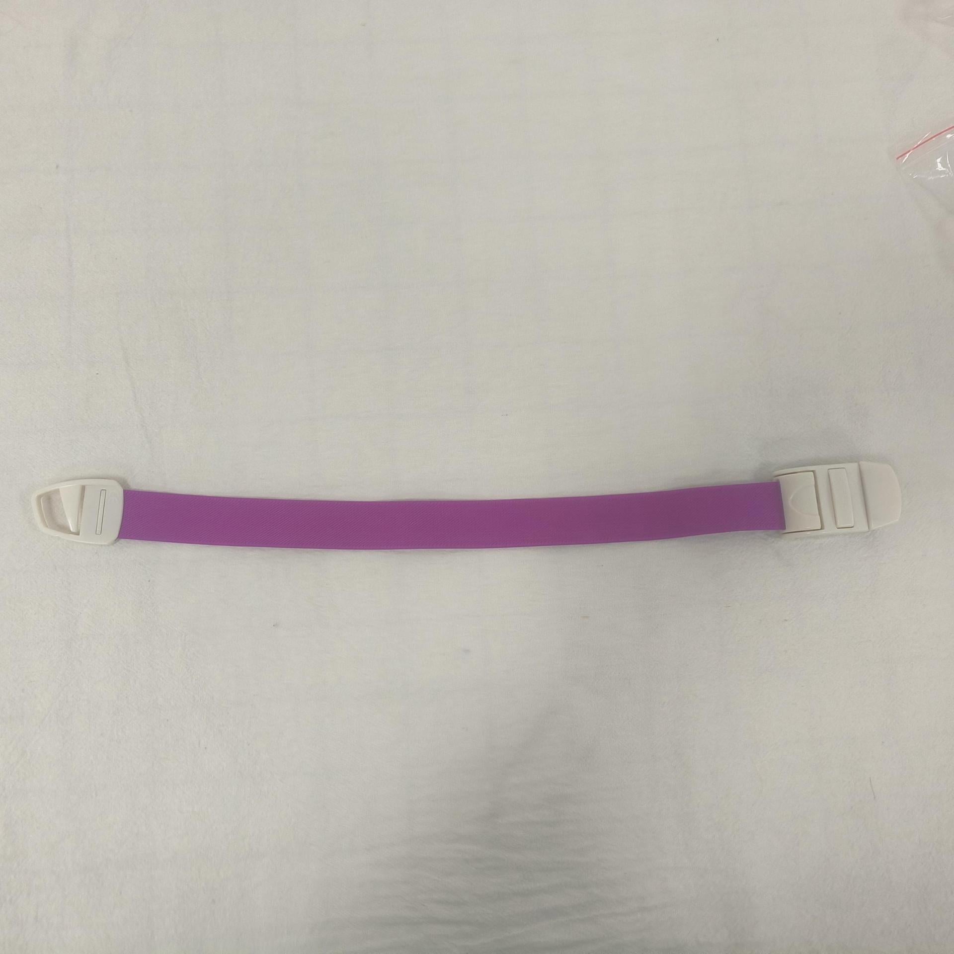 Single purple elastic quick release tourniquet band with a white snap buckle laid flat