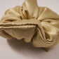 Black satin hair scrunchie on a light surface