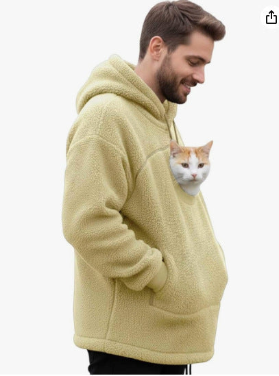 Pale yellow sherpa fleece pet pouch hoodie on a man carrying a cat in the pouch