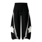 Star patch drawstring pants styled within a modern interior setting