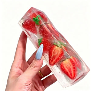 Translucent fruit ice cube squishy toy showing strawberry slices in clear plastic