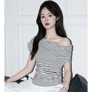 Striped off-shoulder top on model showing diagonal neckline and short cap sleeve
