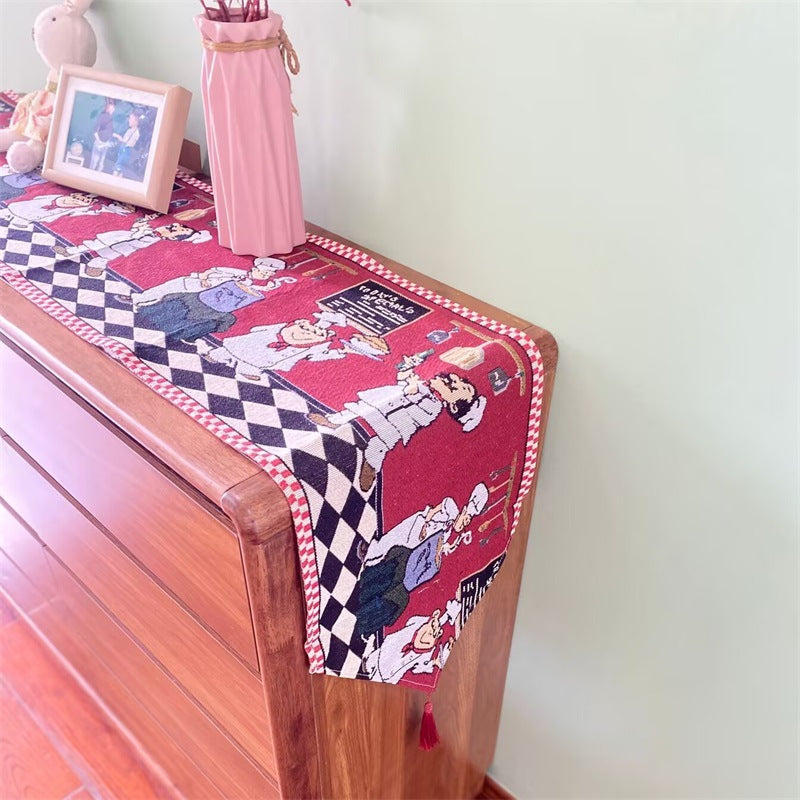 Christmas table runner with cartoon chef pattern with checkerboard border on a sideboard, 33x120 cm option