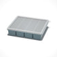 Flexible platinum silicone ice cube tray with the lid lifted off for portioning purees