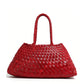 Red woven PU handbag with two braided handles on a white background, Red variant