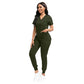 Stretch knit scrub top flexing as the model reaches across
