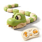 Green remote control magnetic snake toy slithering across a paved stone courtyard
