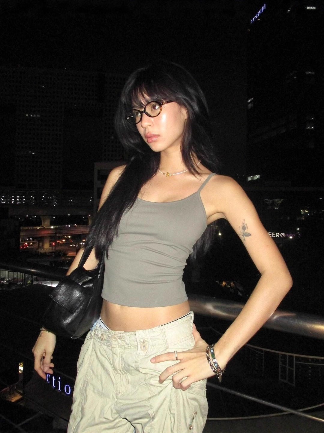 Flat lay of a spaghetti strap scoop neck cami showing the thin straps