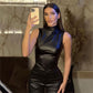 Detail of the draped mock neck against the shoulder of the faux leather top