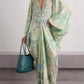 Light green printed maxi dress with deep V-neck and wide sleeves, front view with flat sandals