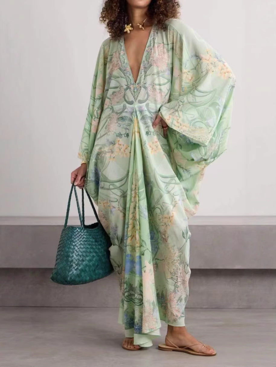 Light green printed maxi dress with deep V-neck and wide sleeves, front view with flat sandals