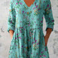 Loose printed tunic with three quarter sleeves with a bordered print building toward the hem