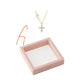 Micro set cubic zirconia cross pendant in a warm gold tone finish, close up