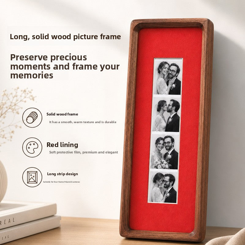 Black walnut photo strip frame with romantic red lining and an acrylic front leaning by a shelf of books