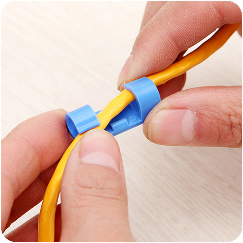 Top down layout of self-adhesive cable clips arranged in transparent white and black