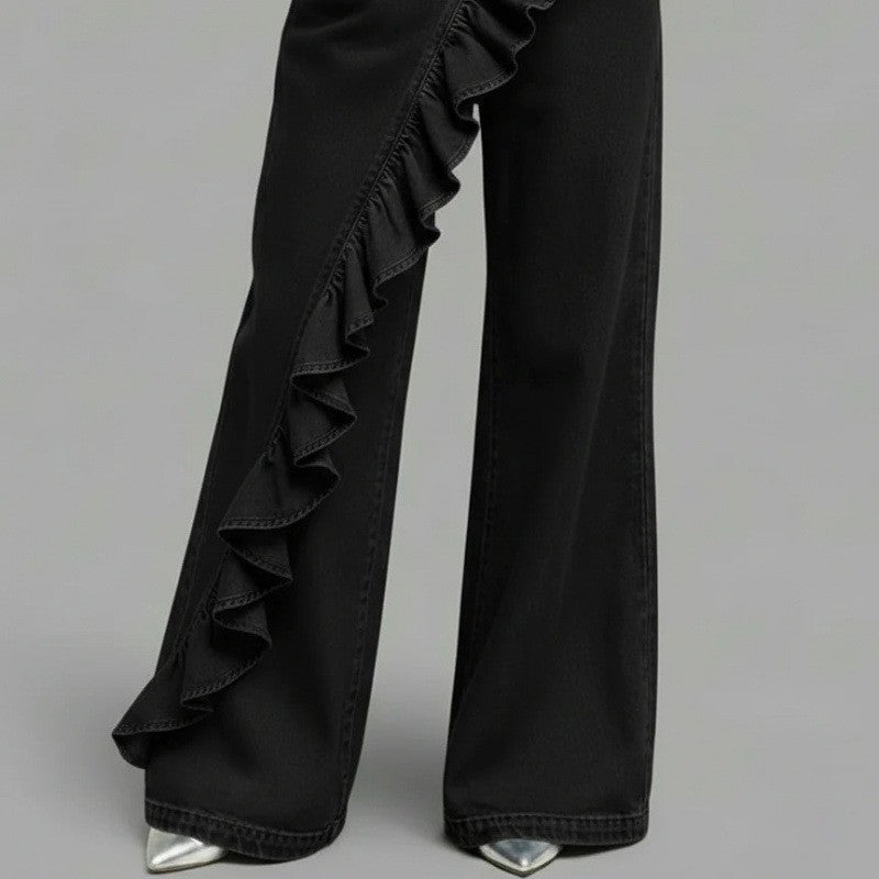 Black wide leg denim trousers with a diagonal cascading ruffle and a long wide leg