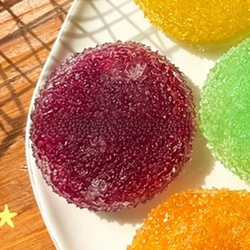 Row of squeeze balls in red blue pink green and purple with textured surfaces