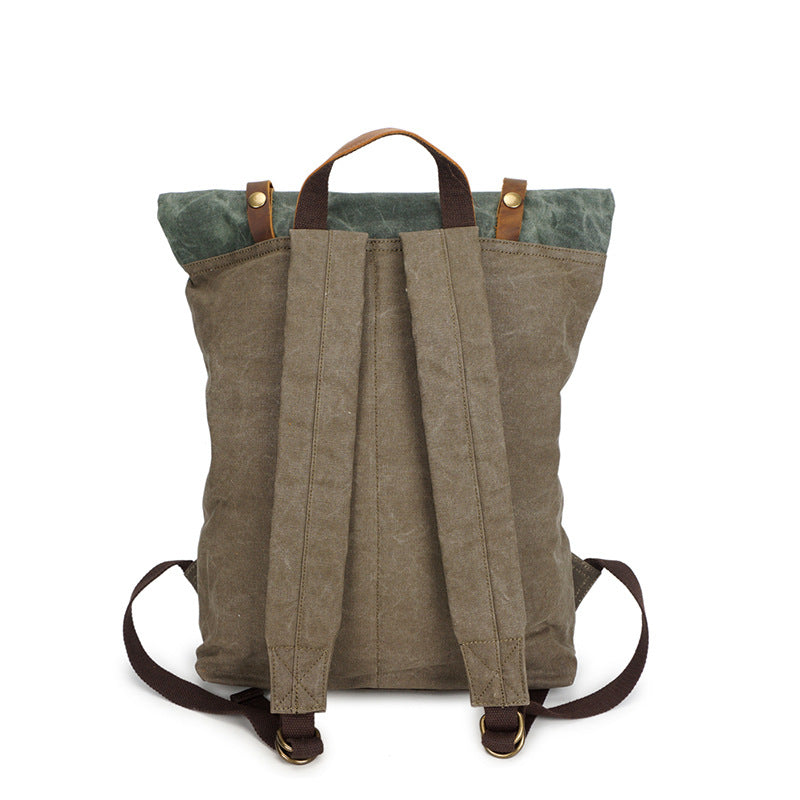 Back view of canvas backpack with two shoulder straps, brown top handle and roll-top straps