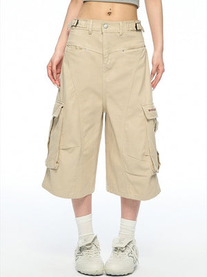 Khaki baggy cotton cargo shorts front view with side belt tabs and flap pockets