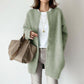 Brushed knit cardigan showing the crew neckline and snap-button front