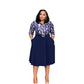 Woman in a navy belted midi dress with printed bodice and pleated swing skirt, front view