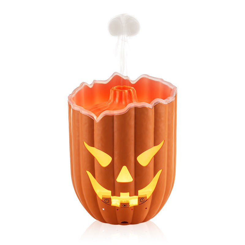 Orange pumpkin humidifier diffuser shown lit with mist rising from the top cone
