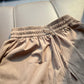 Detail of the ice silk shorts side seam pocket stitched flat against the hip