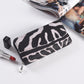 Leopard print PU long wallet with a zip around closure shown beside a magazine