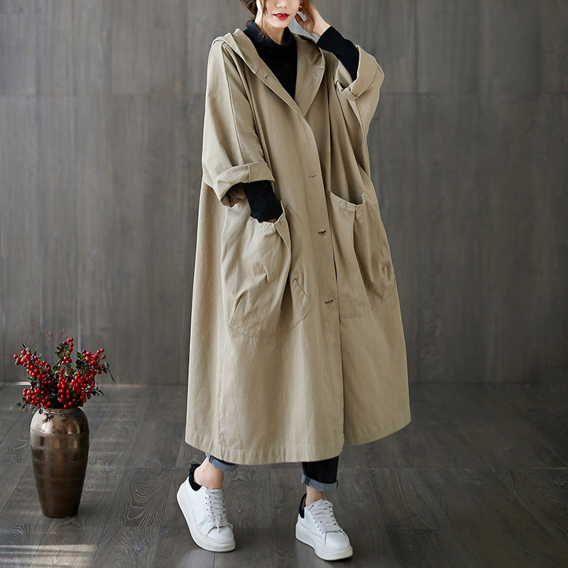 Below the knee hooded coat with rolled long sleeve cuffs on a plain background