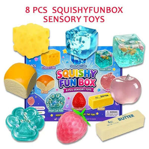 Eight squishy toys laid around the open blue box, cheese cube, bread, butter stick and gel cubes