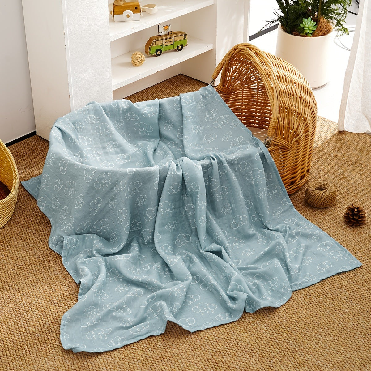 Soft cotton muslin gauze baby blanket shown folded, revealing the light open double layer weave