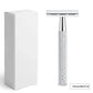 Silver chrome double edge safety razor standing next to a plain white box